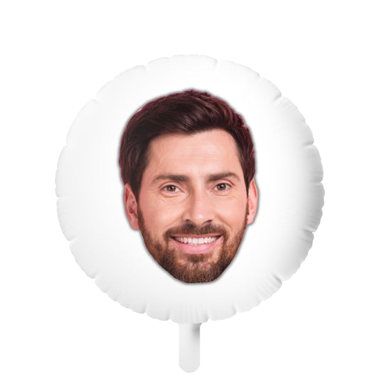 A custom face photo balloon featuring a guy's face in the center.